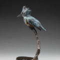 Photo of bronze sculpture of king fisher on branch next to dragon fly with granite base