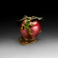 Photo of small bronze Sculpture featuring Tree Frog on two-toned apple with several insects