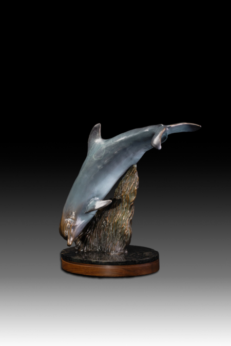 Photo of bronze Sculpture featuring Bottle Nose Dolphin with light blue patina on turntable base