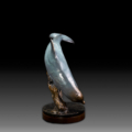 Photo of bronze Sculpture featuring Bottle Nose Dolphin with light blue patina on turntable base